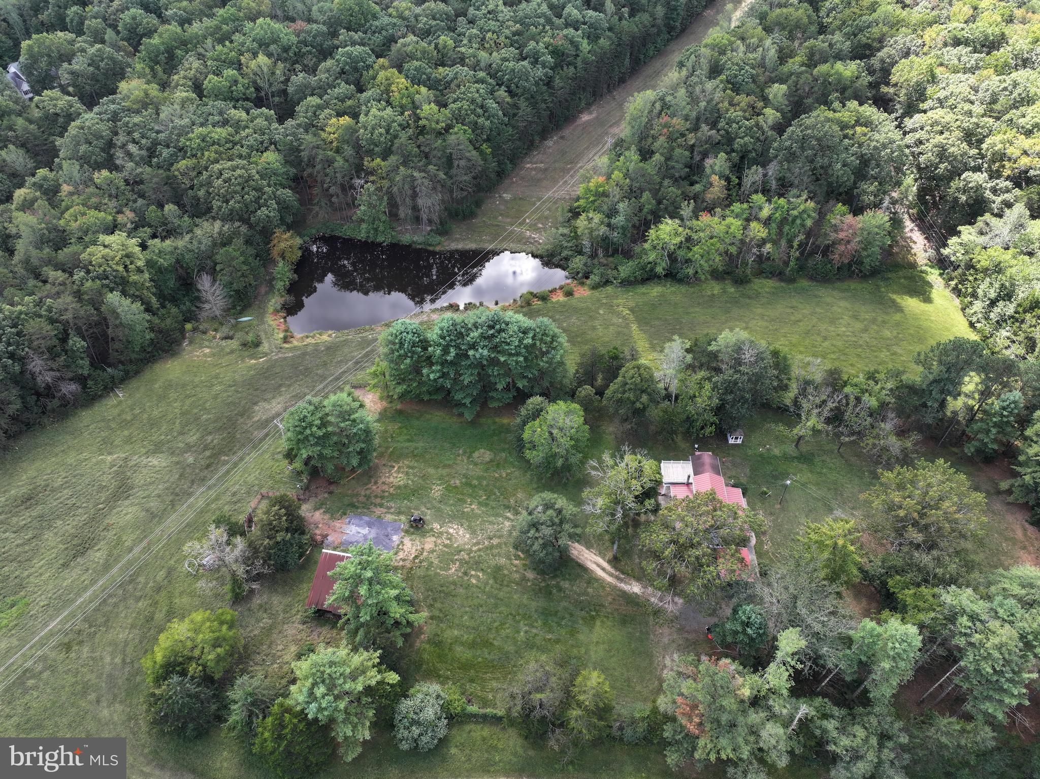 31934 Indiantown Road Locust Grove, VA 22508 - Photo 52 of 60 an aerial view of green landscape with trees houses and mountain view
