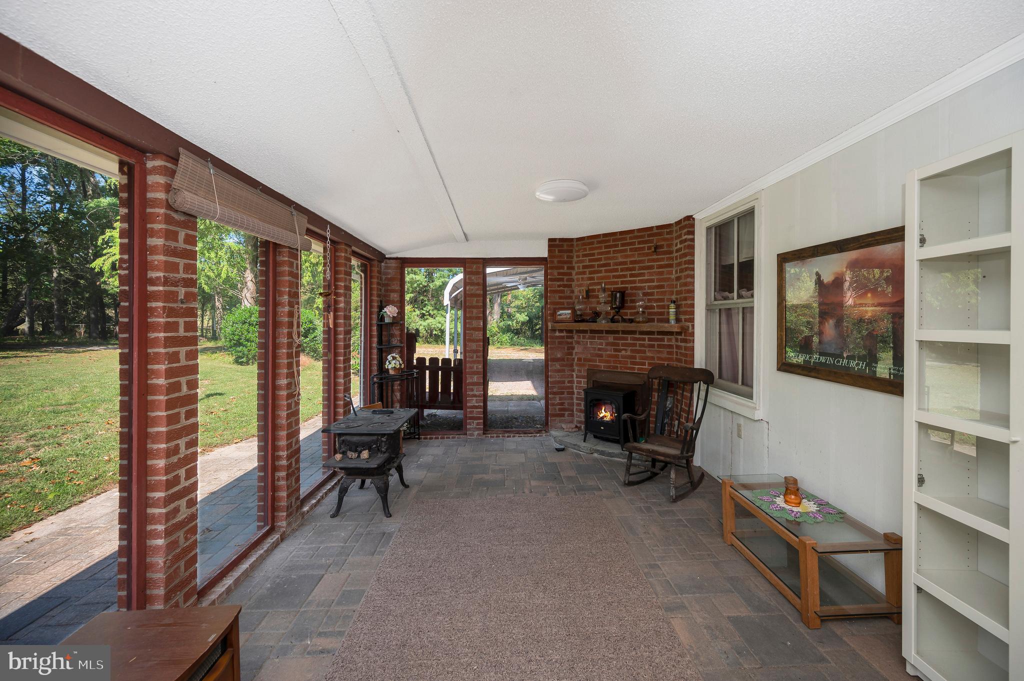 31934 Indiantown Road Locust Grove, VA 22508 - Photo 7 of 60 a living room with furniture floor to ceiling window and a flat screen tv