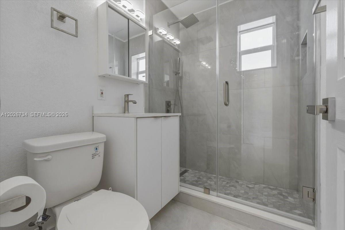 266 Southwest 6th Street Dania Beach, FL 33004 - Photo 10 of 37 a bathroom with a toilet sink and shower