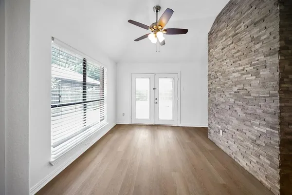 wooden floor in an empty room with a window