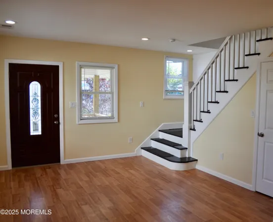 a view of an entryway with wooden floor