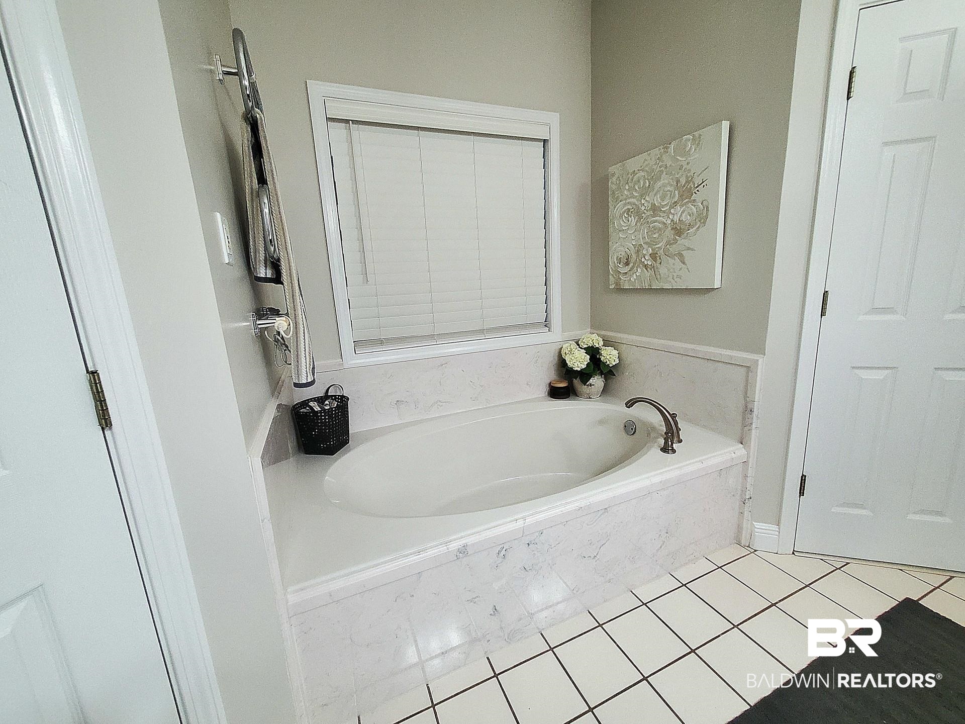 31163 Woodland Way Daphne, AL 36527 - Photo 15 of 44 Bathroom with tiled tub and tile patterned floors