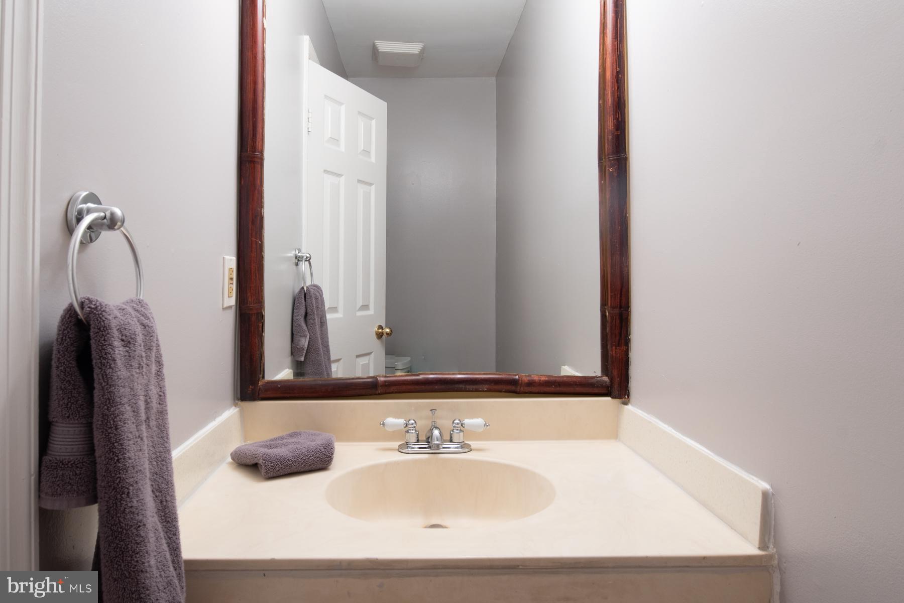 8603 Bradford Road, Unit 105 Silver Spring, MD 20901 - Photo 14 of 36 a bathroom with a sink and a mirror