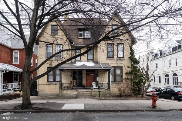 a front view of a building and trees