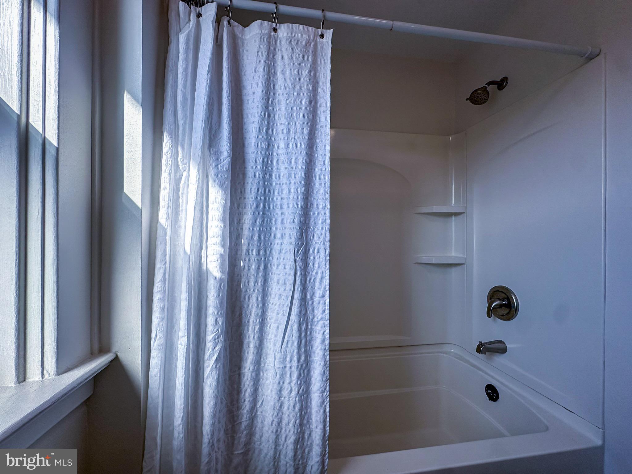 36 North College Street Palmyra, PA 17078 - Photo 32 of 63 a bathroom with a glass shower door