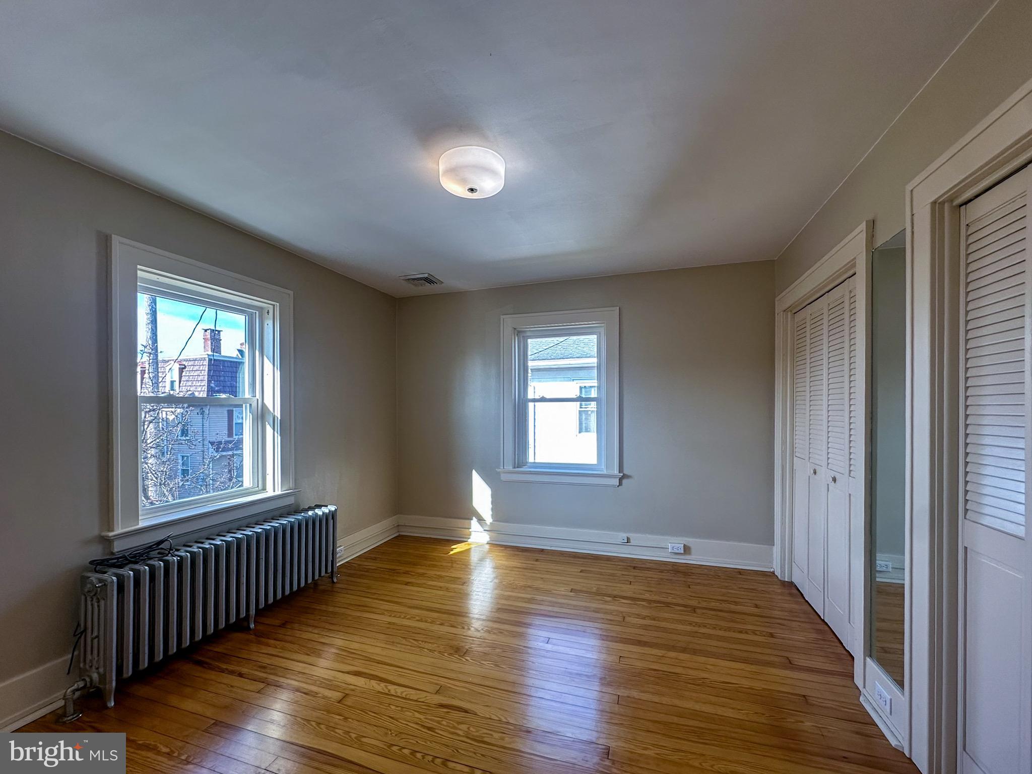 36 North College Street Palmyra, PA 17078 - Photo 34 of 63 an empty room with wooden floor and windows