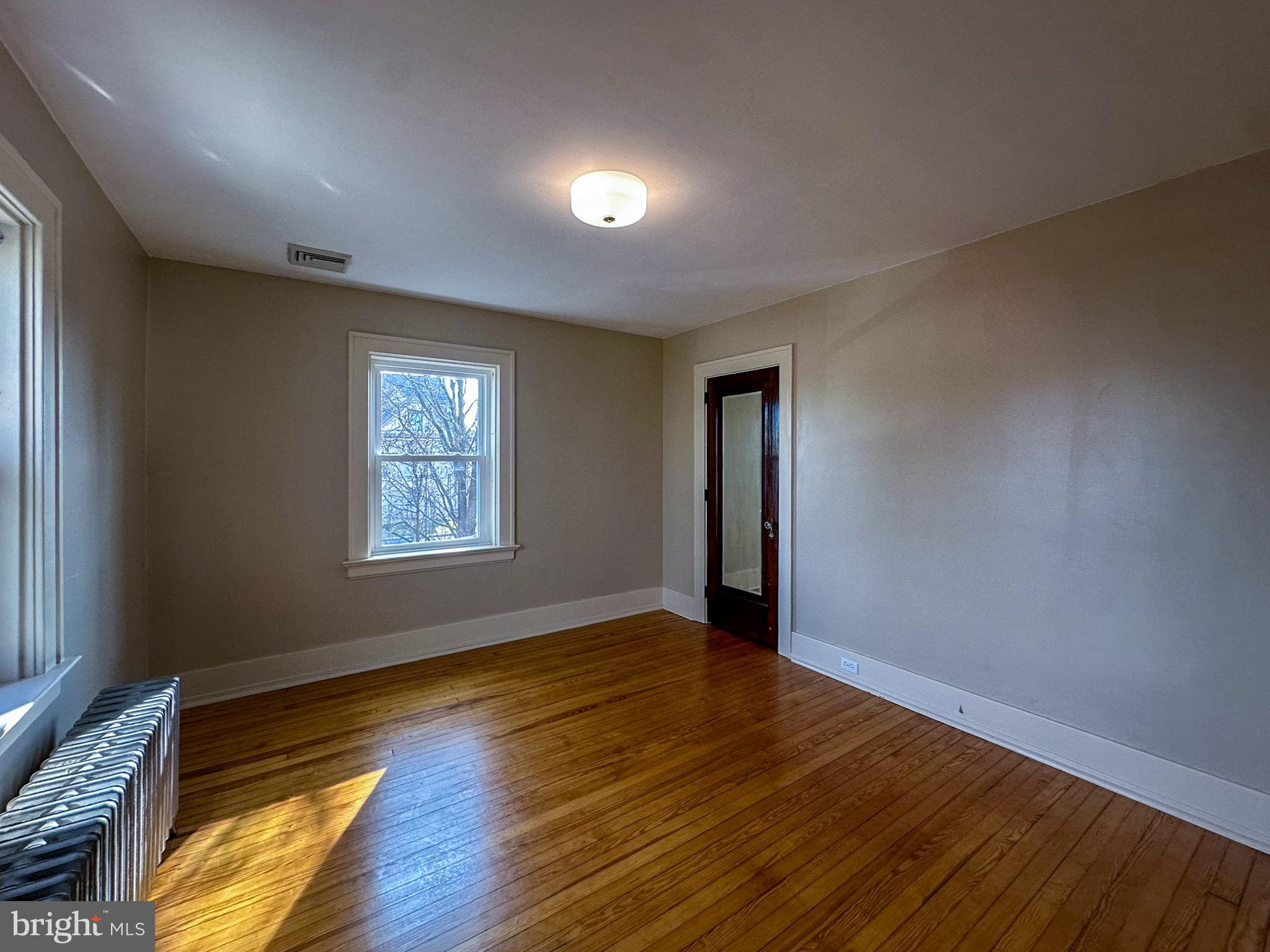 36 North College Street Palmyra, PA 17078 - Photo 40 of 63 a view of an empty room with wooden floor and a window