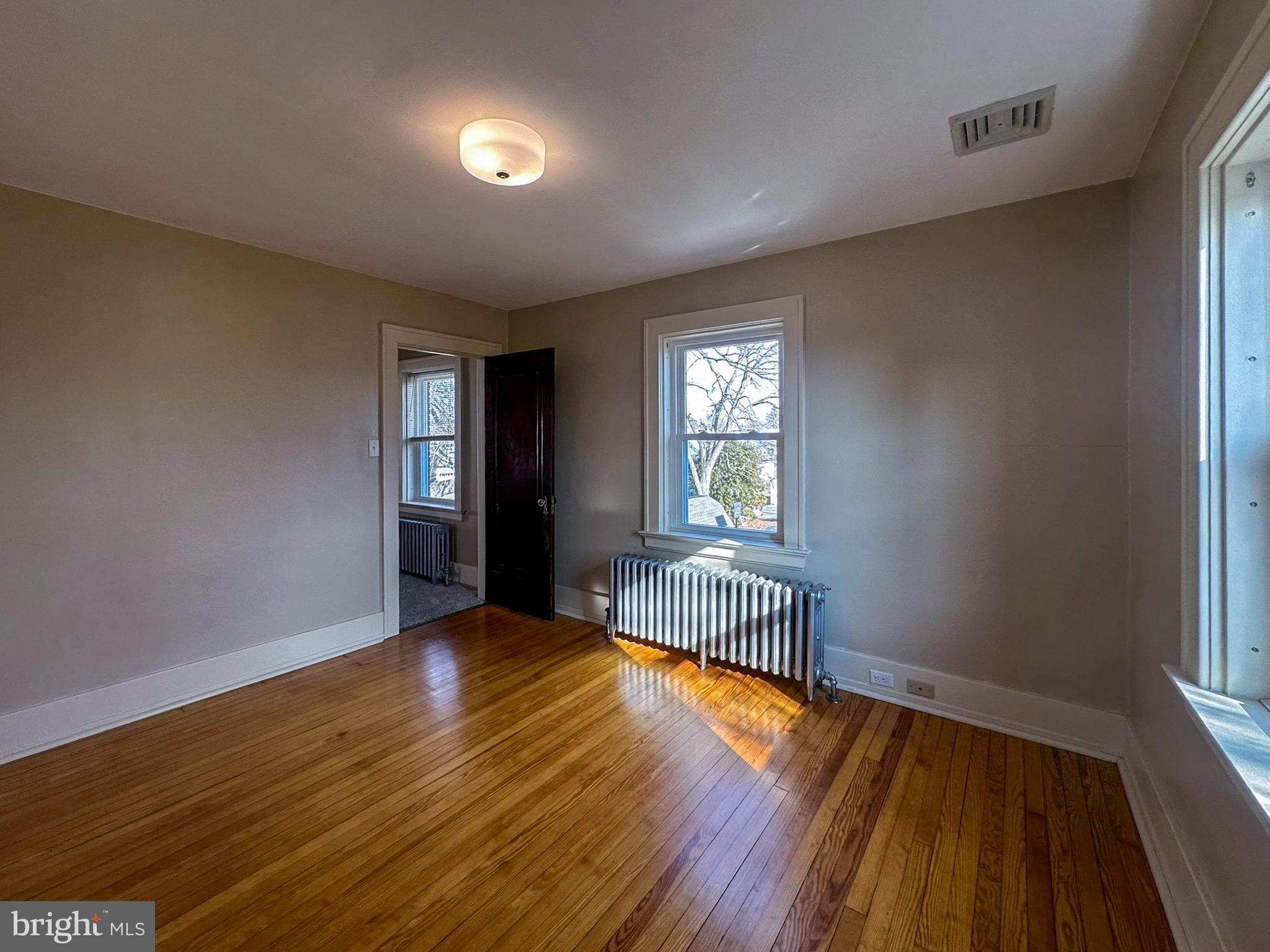 36 North College Street Palmyra, PA 17078 - Photo 41 of 63 an empty room with wooden floor and windows