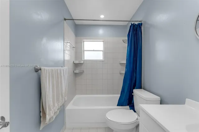 a bathroom with a toilet and a bath tub