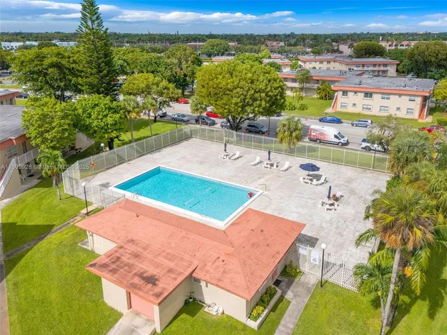 an aerial view of a house with a swimming pool yard and outdoor seating