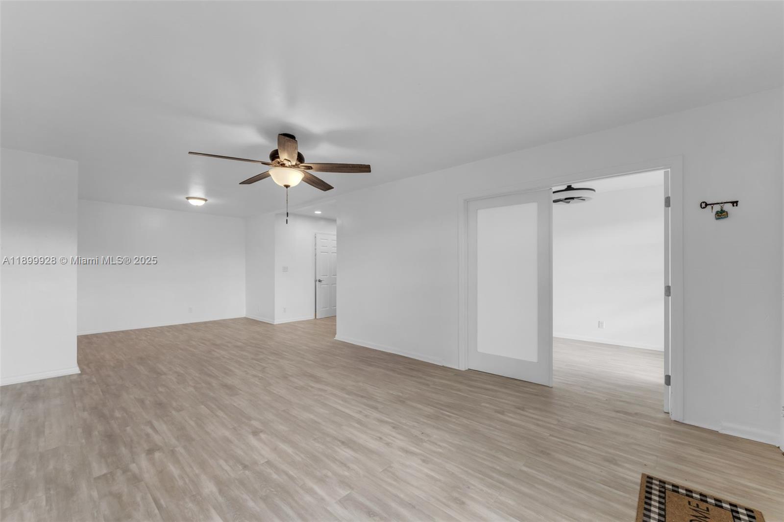 12820 Southwest 43rd Drive, Unit 233B Miami, FL 33175 - Photo 2 of 22 a view of empty room with wooden floor and ceiling fan