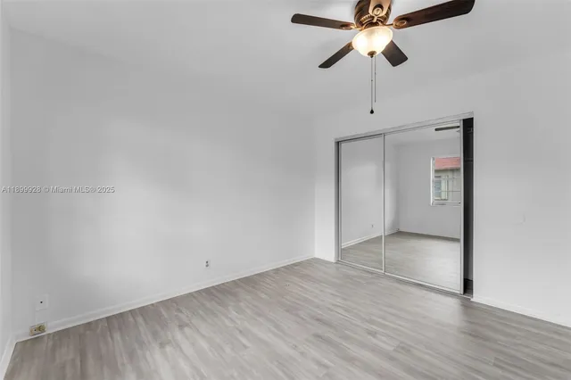 a view of an empty room and wooden floor