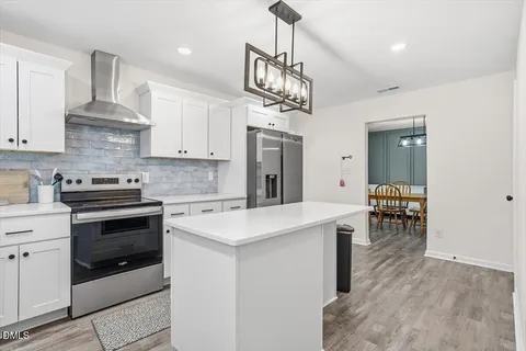 a kitchen that has a lot of cabinets in it
