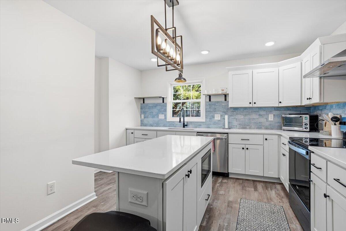 962 Laurel Mill-Centerville Road Louisburg, NC 27549 - Photo 12 of 31 a kitchen with a sink cabinets and window