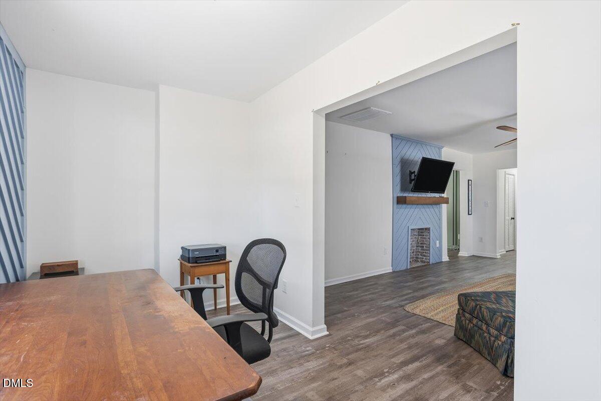 962 Laurel Mill-Centerville Road Louisburg, NC 27549 - Photo 13 of 31 a workspace with furniture and wooden floor