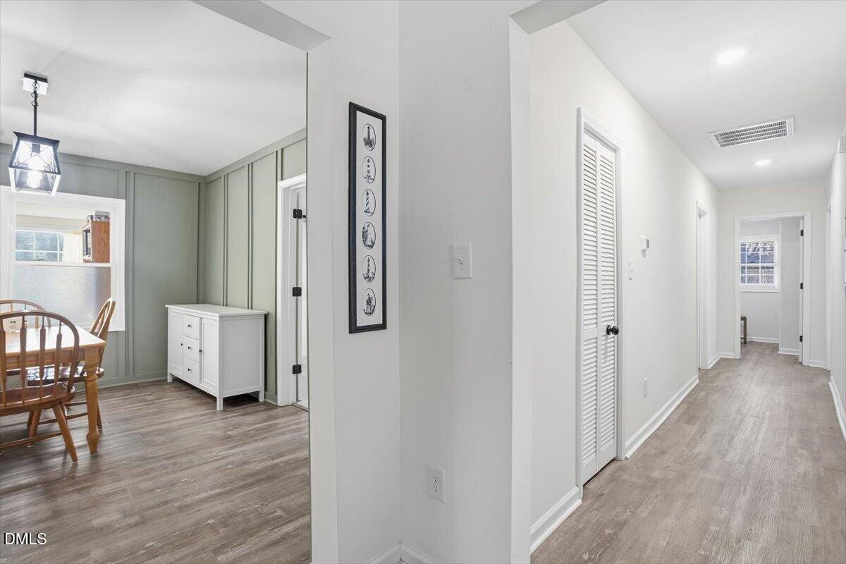 962 Laurel Mill-Centerville Road Louisburg, NC 27549 - Photo 7 of 31 a view of a hallway with wooden floor and furniture