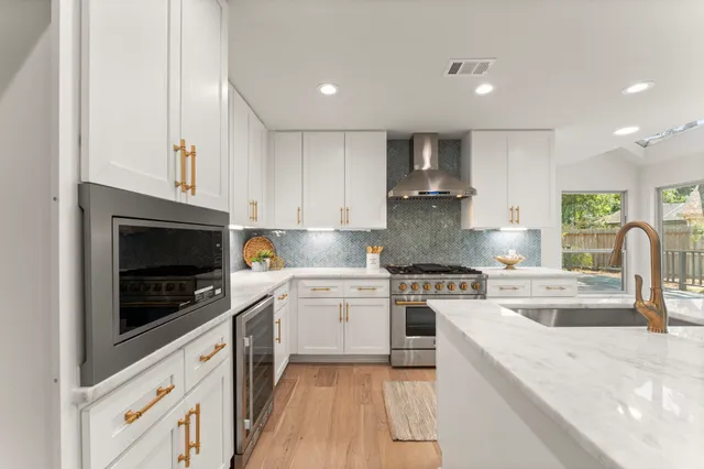 a kitchen with a white stove top oven and cabinets