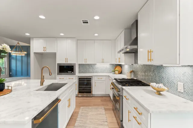 a kitchen with a stove sink and cabinets