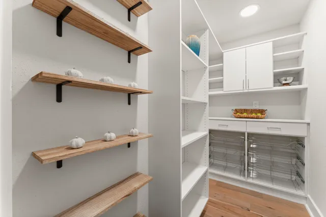 a view of walk in closet with empty racks