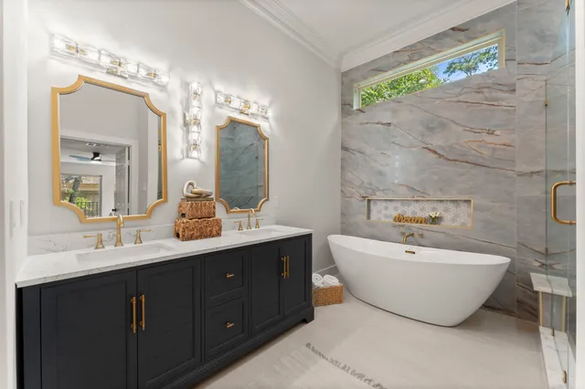 a bathroom with a double vanity sink mirror and bathtub