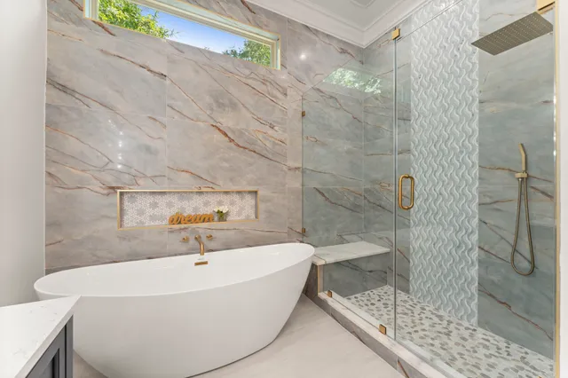 a bathroom with a bathtub and shower