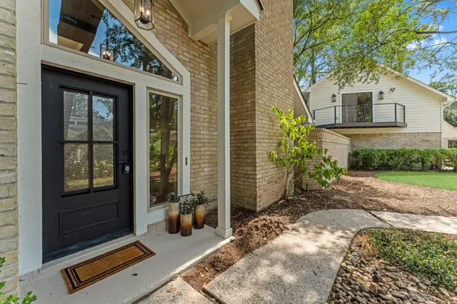 a view of a two chair in the patio with potted plants