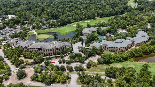 an aerial view of residential house with outdoor space and swimming pool
