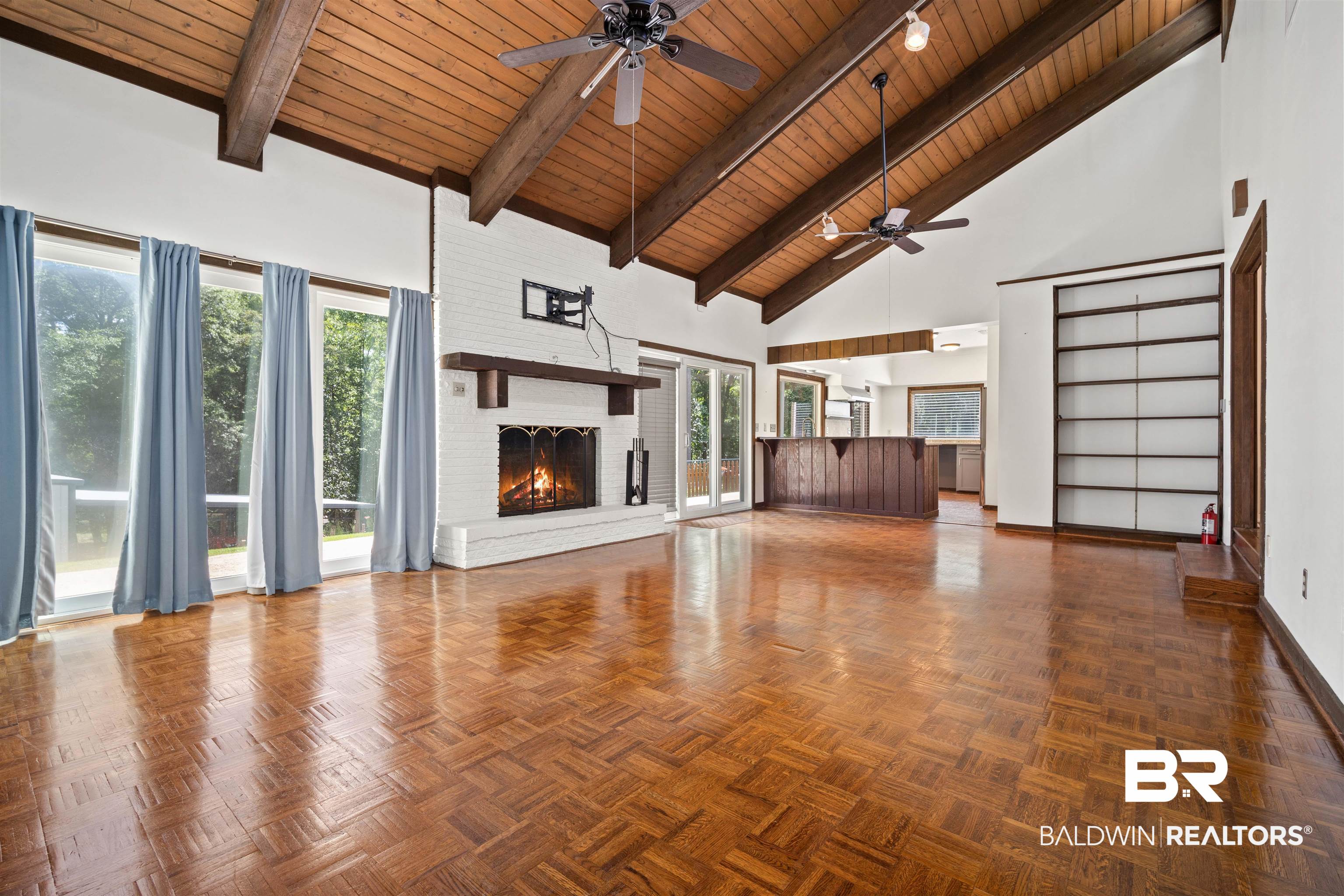 7912 Yorkhaven Road Mobile, AL 36695 - Photo 7 of 41 Unfurnished living room with high vaulted ceiling, a brick fireplace, a wooden ceiling with exposed beams, and a ceiling fan