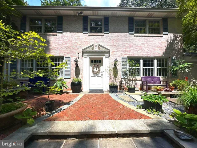 a living room with furniture a fireplace and a dining table with wooden floor