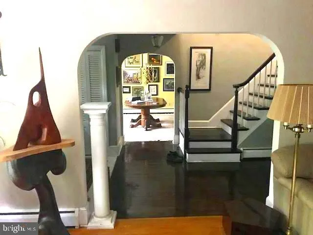 a picture of a room with a white wall and a painting