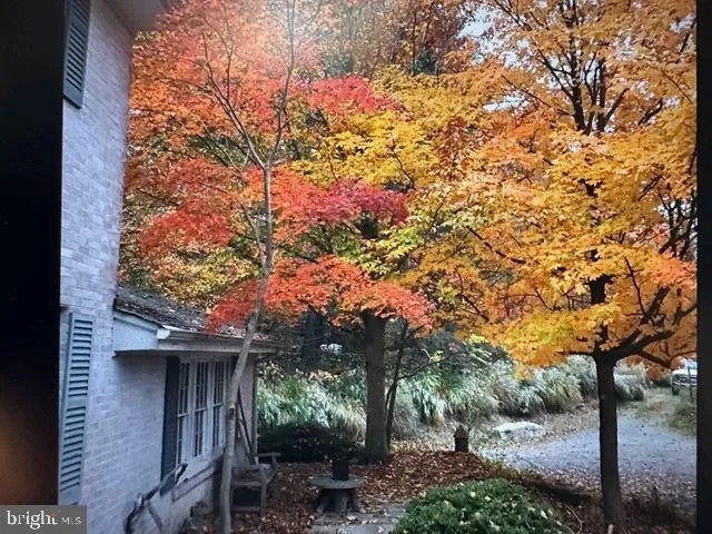 a view of a hallway with wooden floor and stairs