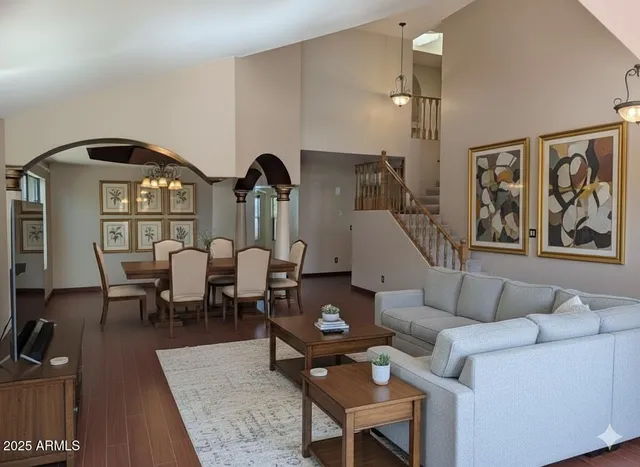 a living room with furniture a rug and a chandelier