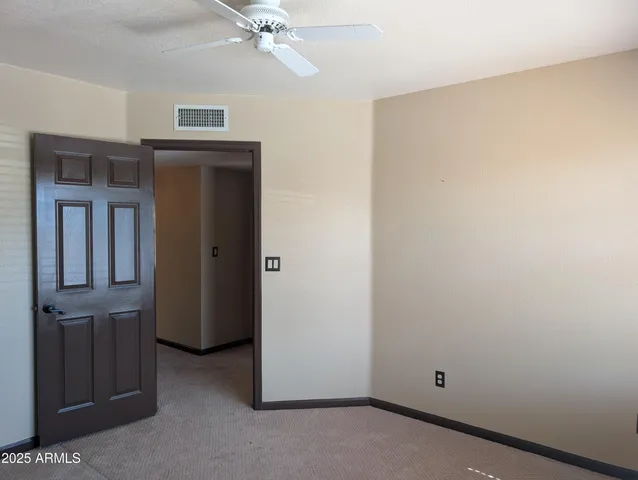 a view of a livingroom with wooden floor and a fireplace
