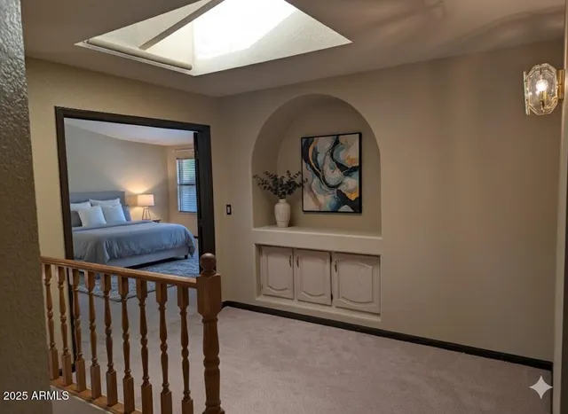 an entryway with wooden floor and mirror