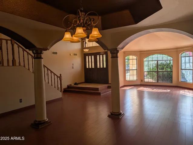a living room with fireplace furniture and a large window