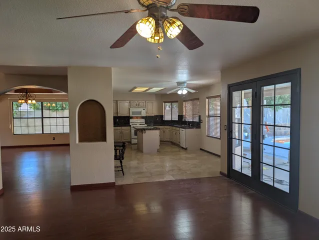 a view of a livingroom with furniture hardwood floor and a ceiling fan