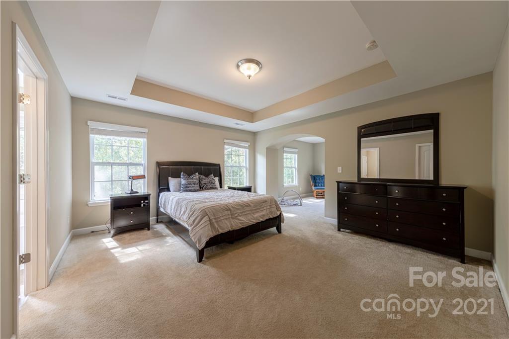 303 Lorraine Road Fort Mill, SC 29708 - Photo 17 of 30 a spacious bedroom with a bed and a dresser