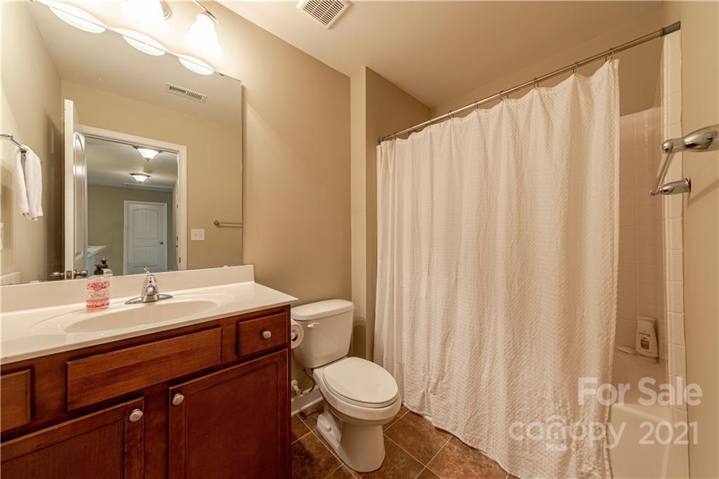 303 Lorraine Road Fort Mill, SC 29708 - Photo 27 of 30 a bathroom with a sink a toilet and shower curtain