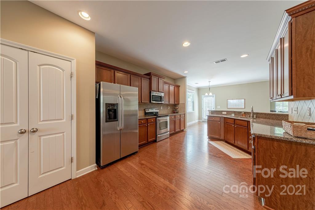 303 Lorraine Road Fort Mill, SC 29708 - Photo 8 of 30 a large kitchen with stainless steel appliances granite countertop a refrigerator and a stove top oven