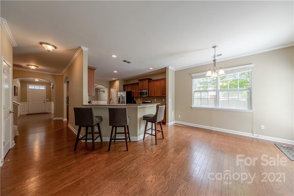 303 Lorraine Road Fort Mill, SC 29708 - Photo 10 of 30 a view of a dining room with furniture and wooden floor