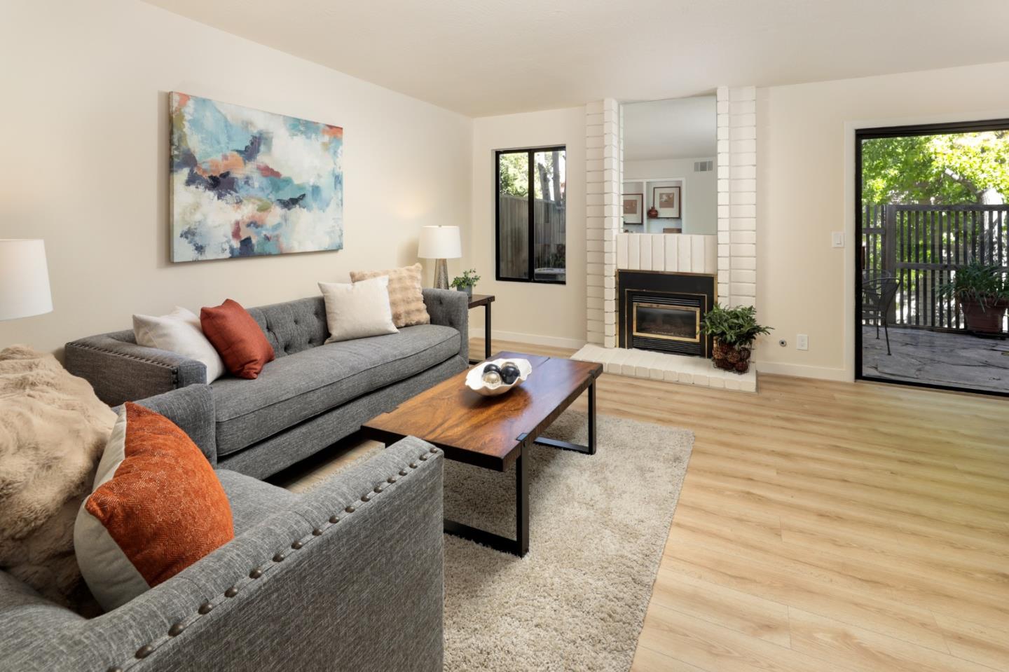 10176 Camberley Lane Cupertino, CA 95014 - Photo 17 of 22 a living room with furniture a fireplace and a floor to ceiling window