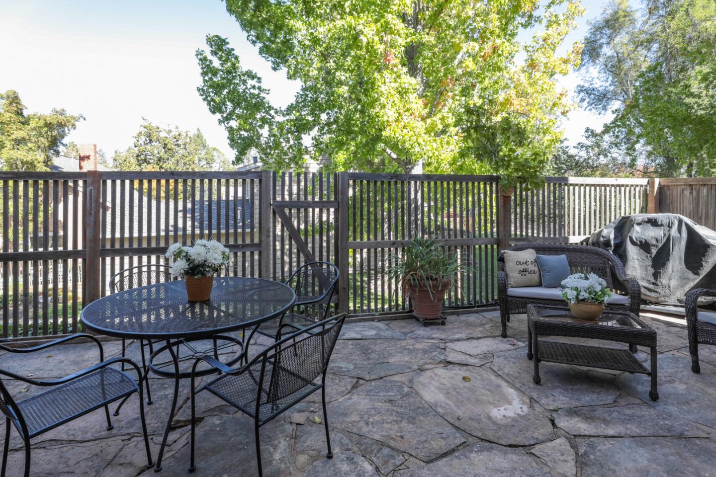 10176 Camberley Lane Cupertino, CA 95014 - Photo 19 of 22 a view of a chairs and table in the back yard of the house