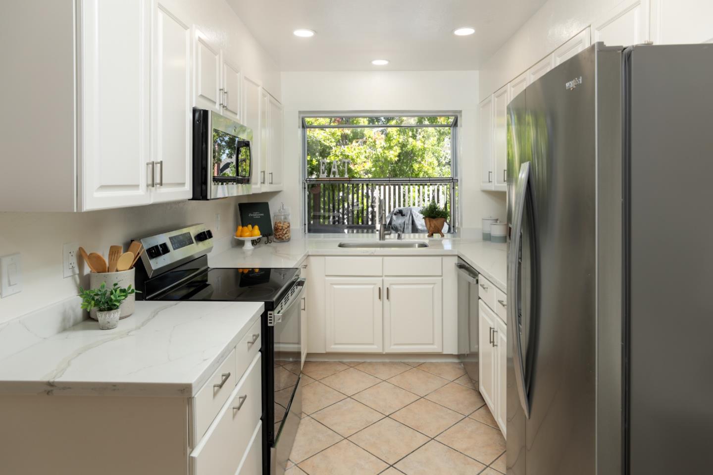 10176 Camberley Lane Cupertino, CA 95014 - Photo 5 of 22 a kitchen that has a sink a refrigerator and a stove top oven