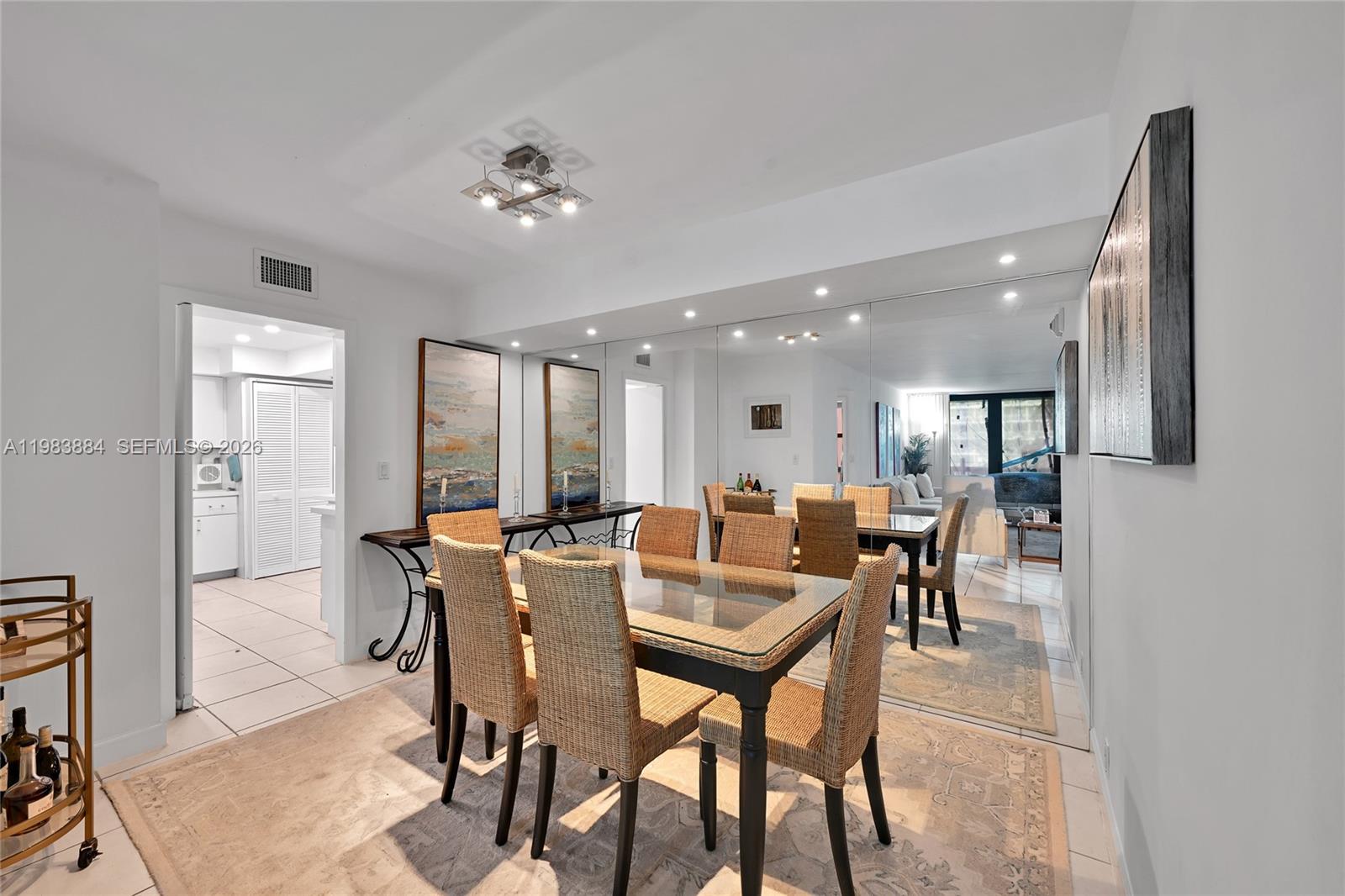 1111 Crandon Boulevard, Unit C504 Key Biscayne, FL 33149 - Photo 1 of 18 a dining room with furniture and a chandelier