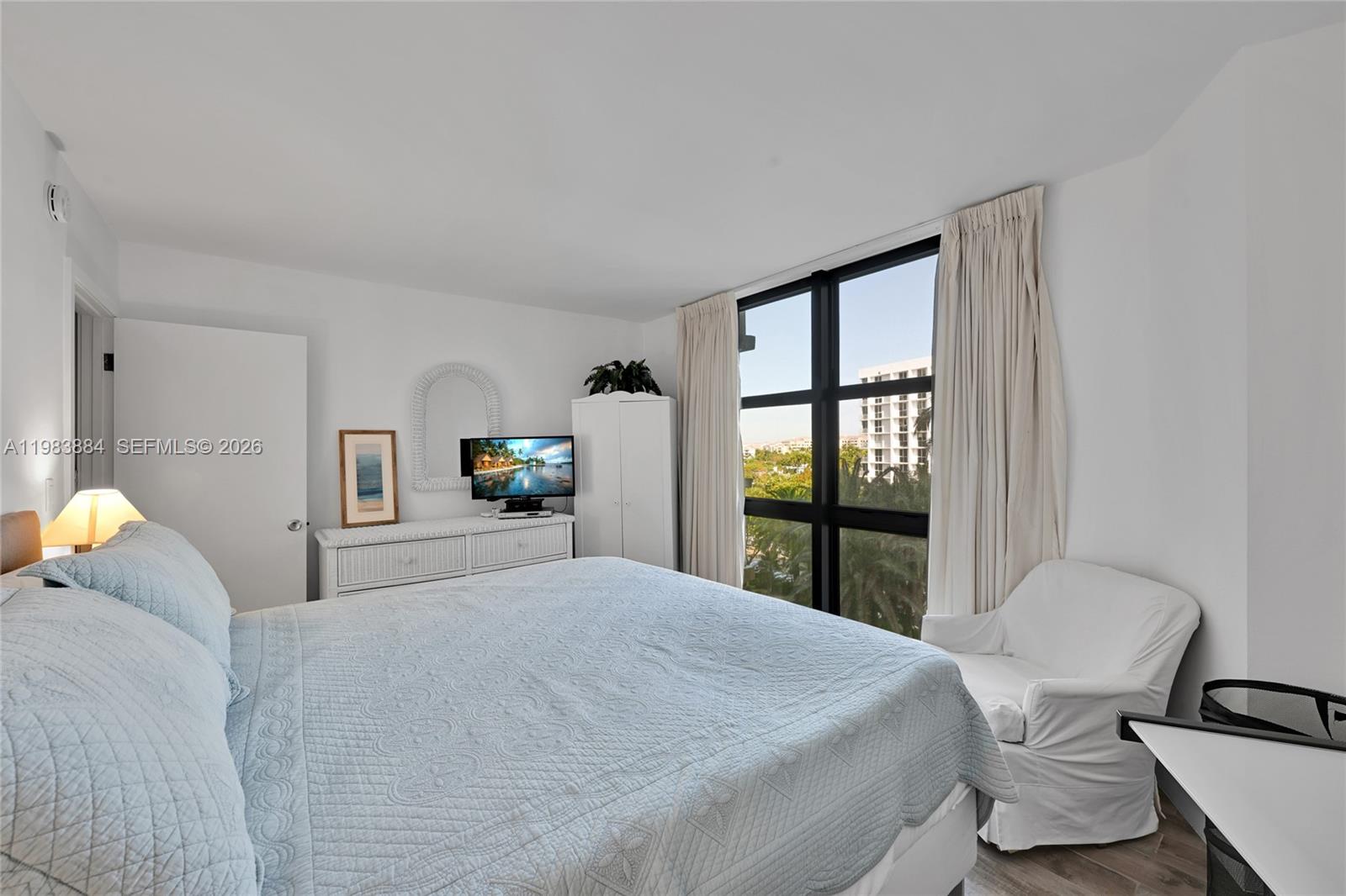 1111 Crandon Boulevard, Unit C504 Key Biscayne, FL 33149 - Photo 9 of 18 a bedroom with a large bed and a window