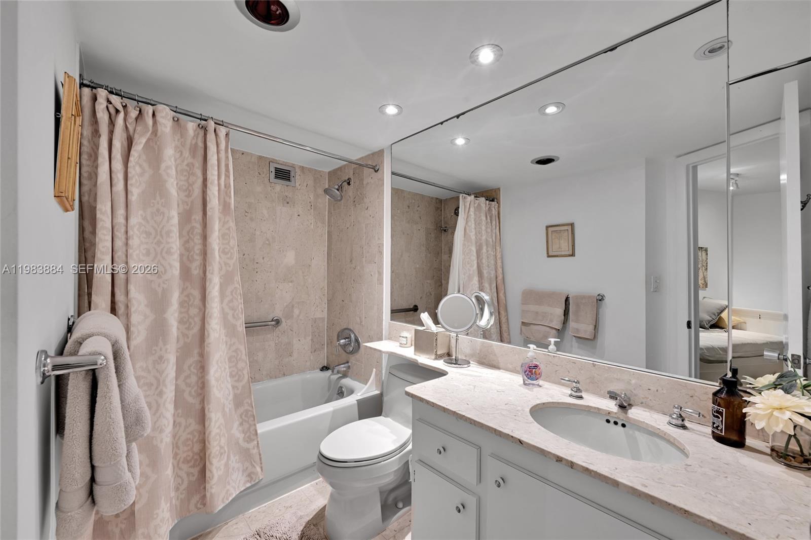 1111 Crandon Boulevard, Unit C504 Key Biscayne, FL 33149 - Photo 10 of 18 a bathroom with a double vanity sink toilet mirror and shower