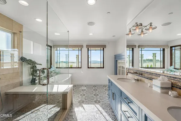 a bathroom with a double vanity sink and a mirror