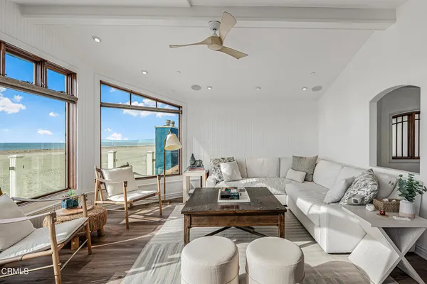 a living room with couches a dining table and with outer view