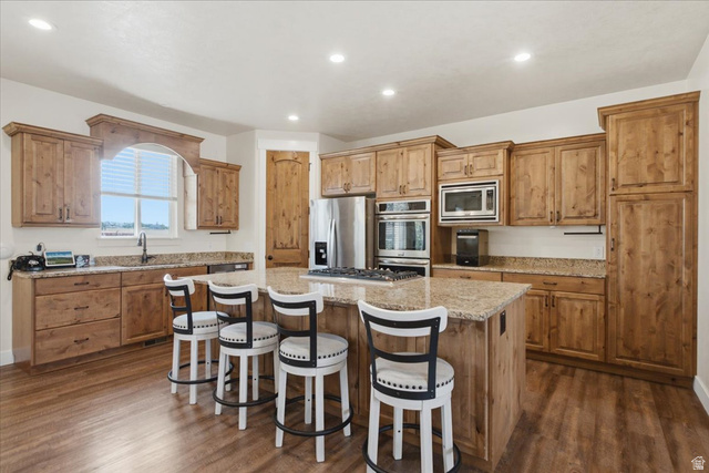 1232 Canyon Road Tooele, UT 84074 - Photo 10 of 54 Kitchen featuring a central island, wood-finish flooring, recessed lighting, and stainless steel appliances