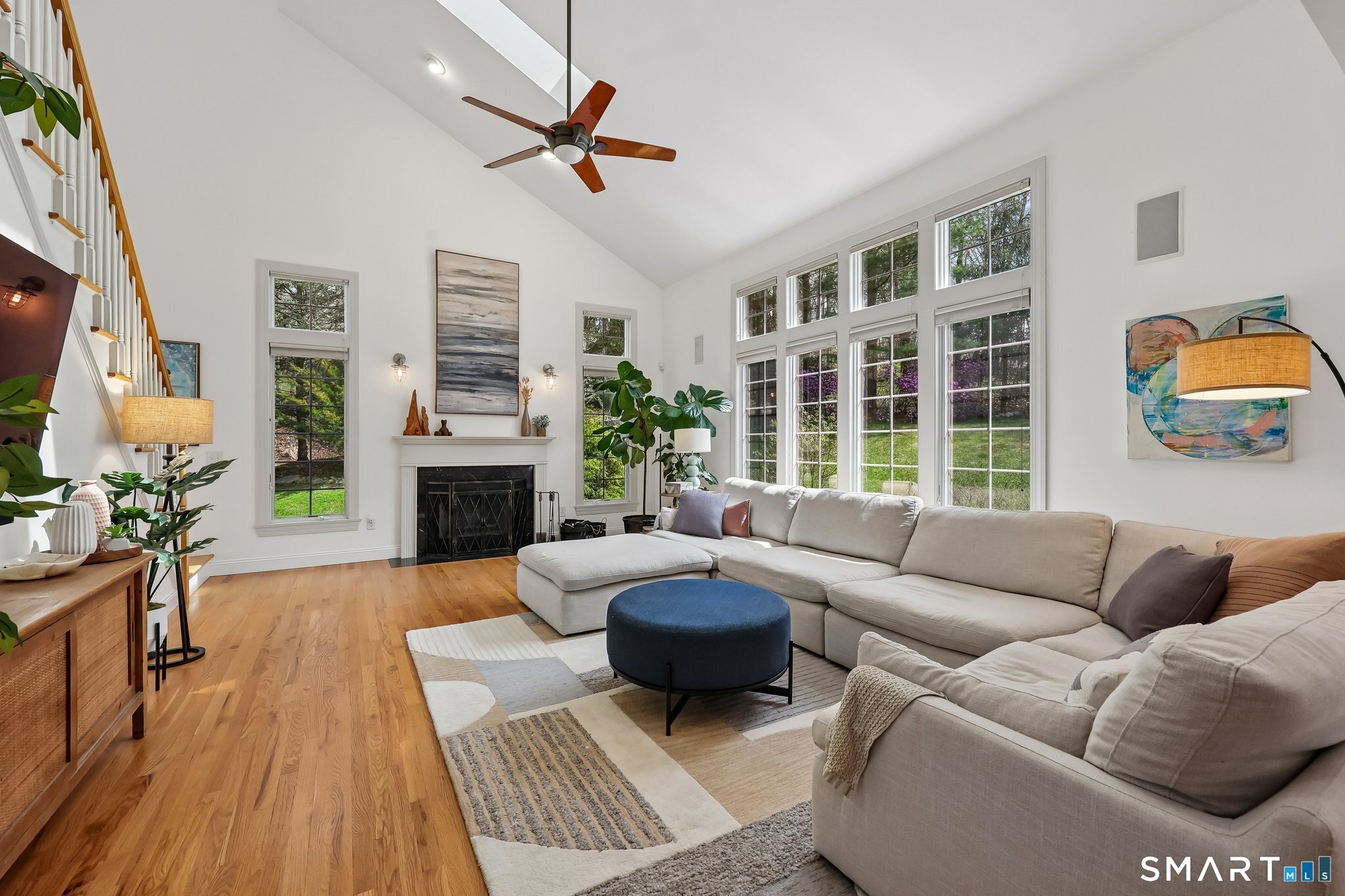 3 East Lake Road Danbury, CT 06811 - Photo 17 of 37 The family room impresses with a soaring ceiling and a dramatic wall of windows that flood the space with natural light while drawing the backyard beautifully into view.